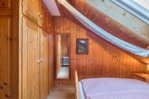 a bedroom with a bed in a wooden house at Ferienwohnung Hofidylle in Münstertal