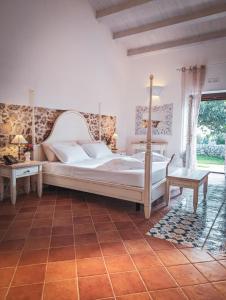 a bedroom with a large bed and a table at Hotel La Corte Del Sole in Noto