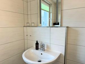 a bathroom with a sink and a mirror at Pension am Plan in Herzberg