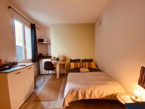 a small bedroom with a bed and a desk at Casa Doutre in Angers