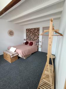 a bedroom with a bed and a wooden ladder at La salamandre de l'escat 