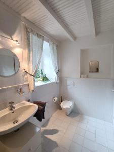 a white bathroom with a sink and a toilet at La salamandre de l'escat chambres et table d'hôtes in Montastruc-de-Salies +41 photos