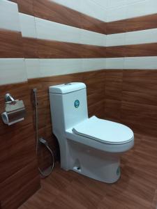 a bathroom with a toilet and a shower at Airport Pearl Garden Transit Hotel in Arambe