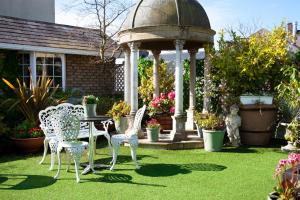 a gazebo with chairs and a table in a garden at Greville Arms Hotel Mullingar in Mullingar