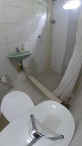 a bathroom with a toilet and a sink and a shower at Hermosa casa ubicada en la playa in Termales - agua caliente - nuqui