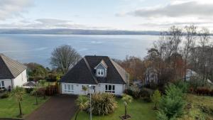 a house with a view of the water at Viewpoint Villa - Luxury 4 Bedroom villa with elevated views in Rothesay