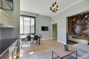 a kitchen and living room with a bed and a table at 114 Suite Deby - Superbe Appartement à Paris in Paris