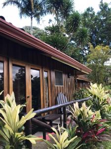 a wooden cabin with a bench in front of it at Hotel Kokoro Mineral Hot Springs in Fortuna