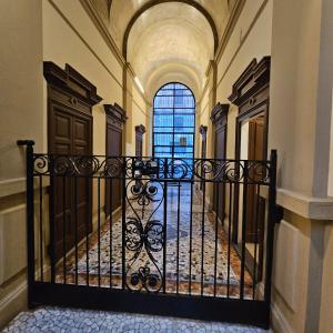 un couloir avec une porte en fer forgé dans un bâtiment dans l'établissement heart of milan Apartment, à Milan