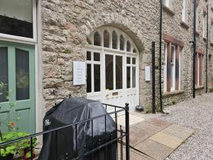 a door of a building with a black tarp in front at Pass the Keys Yew Tree Stunning Apartment with Sea View in Grange Over Sands
