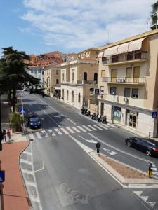 an empty city street with a person standing on the sidewalk at Il mare in valigia in Imperia