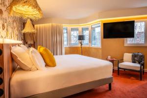 ein Hotelzimmer mit einem Bett und einem TV in der Unterkunft Kopster Hotel Paris Porte de Versailles in Paris