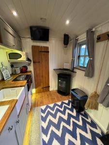 a kitchen with a zebra rug in a tiny house at Lavender Retreat with Private Hot Tub in Upper Hulme