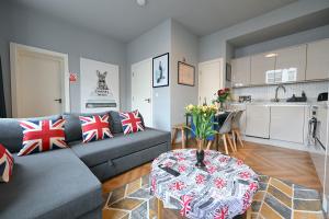 a living room with a couch and a table at 1 BEDROOM FLAT IN WOOD GREEN PICCADILLY LINE in London