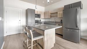 a kitchen with a counter and a refrigerator at Landing - Modern Apartment with Amazing Amenities (ID7703X6) in Salt Lake City