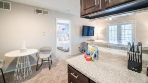 a kitchen with a counter and a table and a room at Landing - Modern Apartment with Amazing Amenities (ID2836X91) in Houston