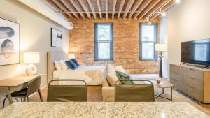 um quarto com uma cama, um sofá e uma televisão em Landing - Modern Apartment with Amazing Amenities (ID5125X39) em Chicago