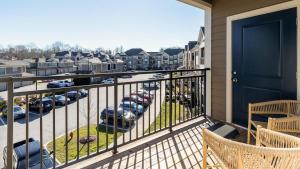a balcony with a view of a parking lot with cars at Landing - Modern Apartment with Amazing Amenities (ID8251X95) in Wake Forest