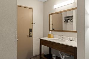 a bathroom with a sink and a mirror at Red Lion Inn & Suites Caseyville in Caseyville