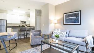 un soggiorno con divano e tavolo di Landing - Modern Apartment with Amazing Amenities (ID2905X13) 