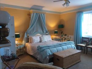 a bedroom with a bed with a blue canopy at JESMOND HOUSE B&B Room3 Superking Ensuite in Hull