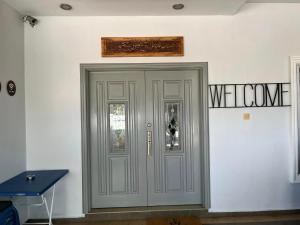 a gray door in a room with a sign on the wall at Rumah Armand Masjid Tanah Melaka 4BR Fully Aircond in Masjid Tanah