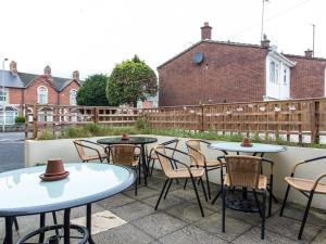 a group of tables and chairs on a patio at The Keyberry Hotel in Newton Abbot