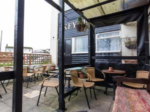 a patio with chairs and tables and a building at The Keyberry Hotel in Newton Abbot