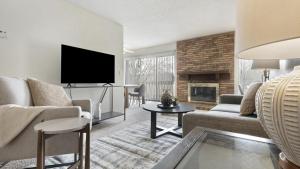 a living room with a couch and a tv at Landing - Modern Apartment with Amazing Amenities (ID9305X02) in Ballwin