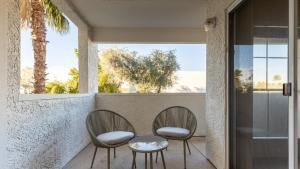 two chairs and a table on a porch with a window at Landing - Modern Apartment with Amazing Amenities (ID8086X70) in Scottsdale