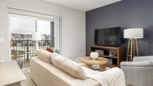 a living room with a couch and a tv at Landing - Modern Apartment with Amazing Amenities (ID8701X65) in Dublin