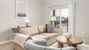 a living room with a couch and a table at Landing - Modern Apartment with Amazing Amenities (ID8701X65) in Dublin