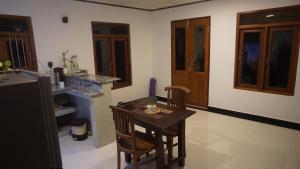 a kitchen with a table and chairs in a room at The Whitegates Lodge in Weligama