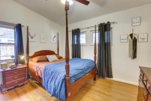 a bedroom with a canopy bed and a dresser at Pet-Friendly Birmingham Cottage with Private Hot Tub in Birmingham