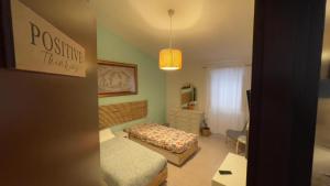 a small bedroom with a bed and a dresser at Itiseasy Cuglieri Luxury Apartments in Cuglieri