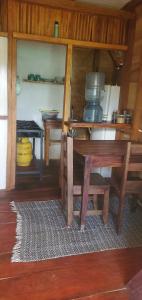 a dining room with a table and a kitchen at Coconut House in El Gigante