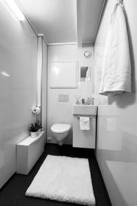 a white bathroom with a toilet and a sink at Central Economic Stavanger in Stavanger
