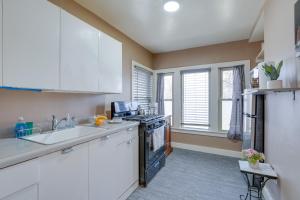 a kitchen with a sink and a stove top oven at Cozy Kalamazoo Studio, 4 Mi to Downtown Area! in Kalamazoo