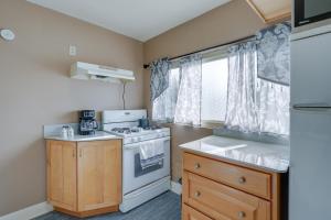 a small kitchen with a stove and a sink at Kalamazoo Vacation Rental Near Golf and Parks! in Kalamazoo