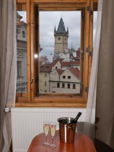 a window with two wine glasses on a table at Kafka Prague rooms in Prague