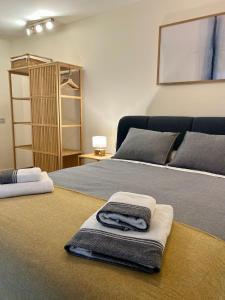 a bedroom with two beds with towels on them at Sol Mediterráneo Palm City in Elche