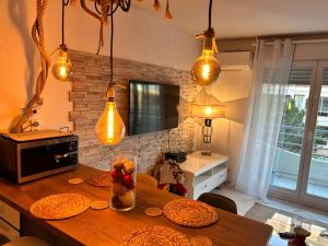 a kitchen with a wooden table and some lights at LaMer in Juan-les-Pins