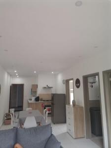 a living room with a couch and a kitchen at Kensington Square Luxury Apartment in Flic-en-Flac