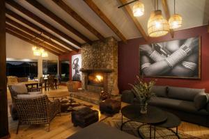 a living room with a couch and a fireplace at Elephant Hide of Knysna Guest Lodge in Knysna