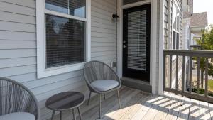 a porch with two chairs and a table and a window at Landing - Modern Apartment with Amazing Amenities (ID4410X01) in Lewis Center