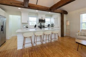 a kitchen with a counter and bar stools at Cape Henry House Inn at Old Beach in Virginia Beach