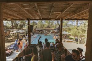 a group of people standing around a swimming pool at Chalet - Piscine - ef0aac in Porto-Vecchio