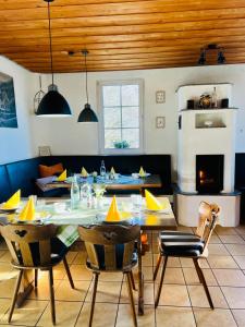 a dining room with a table and some chairs at TheCrossing Bed & Breakfast in Hausen im Tal