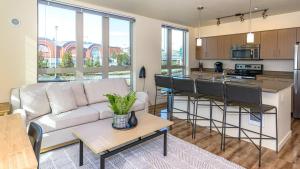 a living room with a couch and a kitchen at Landing - Modern Apartment with Amazing Amenities (ID8687X92) in Tacoma