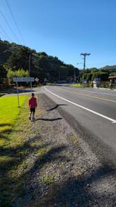 a child walking down the side of a road at Cozy Home in Volcán